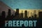 Abstract silhouette of the city with text Freeport at the vintage bahamas flag