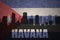 Abstract silhouette of the city with text Havana at the vintage cuban flag