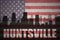 Abstract silhouette of the city with text Huntsville at the vintage american flag