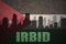 abstract silhouette of the city with text Irbid at the vintage jordan flag