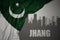 Abstract silhouette of the city with text Jhang near waving national flag of pakistan on a gray background.3D illustration