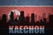 Abstract silhouette of the city with text Kaechon at the vintage north korea flag