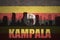 Abstract silhouette of the city with text Kampala at the vintage ugandan flag