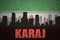 Abstract silhouette of the city with text Karaj at the vintage iranian flag