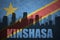 Abstract silhouette of the city with text Kinshasa at the vintage democratic republic of the congo flag
