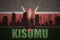 Abstract silhouette of the city with text Kisumu at the vintage kenyan flag