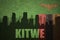 Abstract silhouette of the city with text Kitwe at the vintage zambian flag