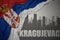 Abstract silhouette of the city with text Kragujevac near waving national flag of serbia on a gray background