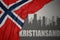 Abstract silhouette of the city with text Kristiansand near waving national flag of norway on a gray background