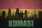 Abstract silhouette of the city with text Kumasi at the vintage ghanaian flag