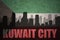 Abstract silhouette of the city with text Kuwait City at the vintage kuwait flag