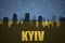 Abstract silhouette of the city with text Kyiv at the vintage ukrainian flag