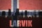 Abstract silhouette of the city with text Larvik at the vintage norwegian flag