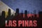 Abstract silhouette of the city with text Las Pinas at the vintage philippines flag