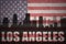 Abstract silhouette of the city with text Los Angeles at the vintage american flag