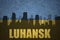 Abstract silhouette of the city with text Luhansk at the vintage ukrainian flag