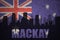 Abstract silhouette of the city with text Mackay at the vintage australian flag