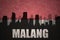 Abstract silhouette of the city with text Malang at the vintage indonesian flag