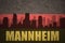 Abstract silhouette of the city with text Mannheim at the vintage german flag