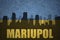 Abstract silhouette of the city with text Mariupol at the vintage ukrainian flag
