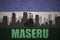 Abstract silhouette of the city with text Maseru at the vintage lesotho flag