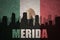 Abstract silhouette of the city with text Merida at the vintage mexican flag