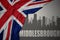 Abstract silhouette of the city with text Middlesbrough near waving national flag of great britain on a gray background