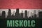 Abstract silhouette of the city with text Miskolc at the vintage hungarian flag