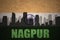 Abstract silhouette of the city with text Nagpur at the vintage indian flag