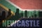 Abstract silhouette of the city with text Newcastle at the vintage south africa flag