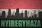 Abstract silhouette of the city with text Nyiregyhaza at the vintage hungarian flag