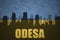Abstract silhouette of the city with text Odesa at the vintage ukrainian flag