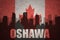 Abstract silhouette of the city with text Oshawa at the vintage canadian flag