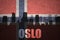 Abstract silhouette of the city with text Oslo at the vintage norwegian flag