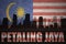 Abstract silhouette of the city with text Petaling Jaya at the vintage malaysian flag