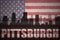 Abstract silhouette of the city with text Pittsburgh at the vintage american flag