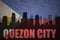 Abstract silhouette of the city with text Quezon City at the vintage philippines flag