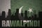 Abstract silhouette of the city with text Rawalpindi at the vintage pakistan flag