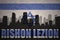 Abstract silhouette of the city with text Rishon LeZion at the vintage israel flag