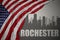 Abstract silhouette of the city with text Rochester near waving national flag of united states of america on a gray background. 3D