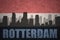 Abstract silhouette of the city with text Rotterdam at the vintage dutch flag