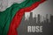 Abstract silhouette of the city with text Ruse near waving national flag of bulgaria on a gray background
