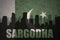 Abstract silhouette of the city with text Sargodha at the vintage pakistan flag