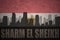 Abstract silhouette of the city with text Sharm El Sheikh at the vintage egyptian flag