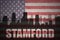 Abstract silhouette of the city with text Stamford at the vintage american flag