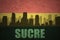 Abstract silhouette of the city with text Sucre at the vintage bolivian flag