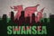 Abstract silhouette of the city with text Swansea at the vintage wales flag