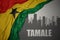 Abstract silhouette of the city with text Tamale near waving colorful national flag of ghana on a gray background