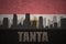 Abstract silhouette of the city with text Tanta at the vintage egyptian flag