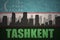 Abstract silhouette of the city with text Tashkent at the vintage uzbekistan flag